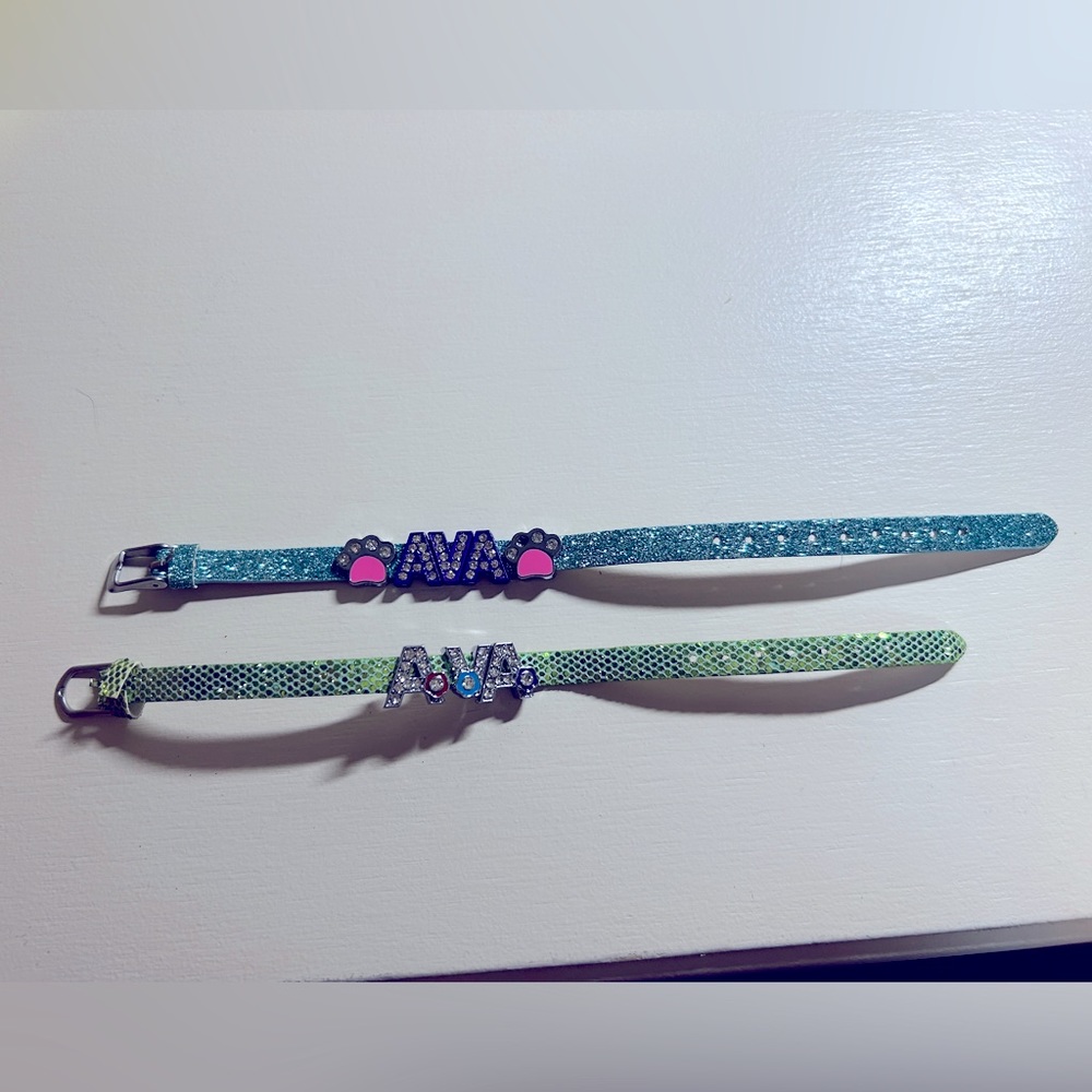 Two girls super cute glitter brackets with name Ava. Gently used